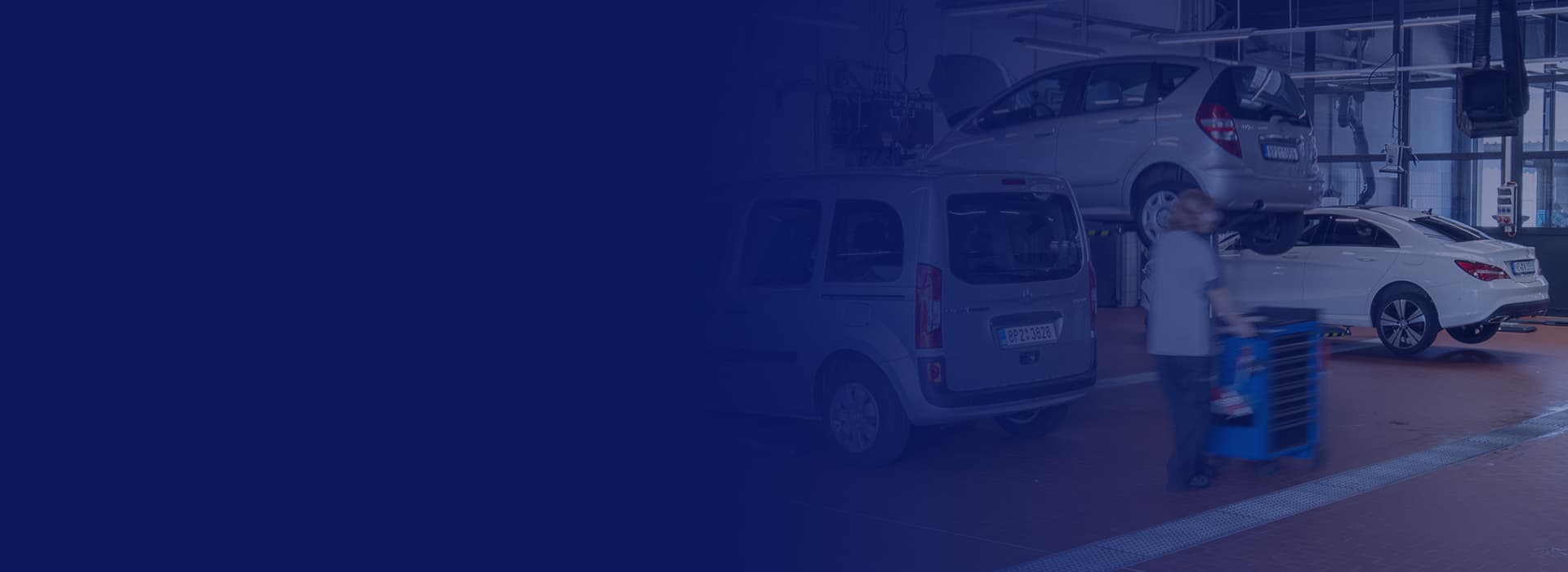 Ein Mitarbeiter eines Autohauses übergibt einen Fahrzeugschlüssel an einen Kunden.