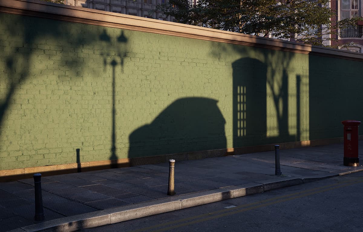 Der Schatten eines smart #2 ist auf einer Wand an einer Stadtstraße zu sehen.